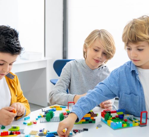 a group of children playing with legos