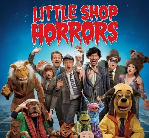 a group of people dressed in costumes for a musical with the sign “little horrors”