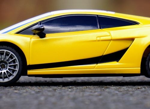 a yellow lambo car with a black and white stripe