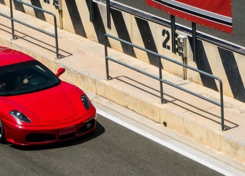 a red sports car driving down a street