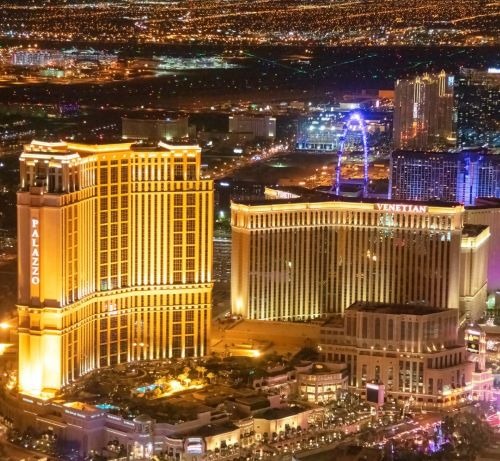 Aerial night view of the illuminated Palazzo and Venetian hotel resorts on the Las Vegas Strip.