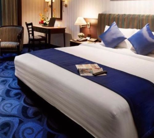 a hotel room with a bed and a chair