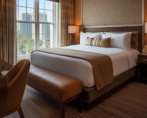 a luxury bed room with a bed and a chair