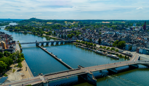a bridge over a river with a bridge over it in maastricht, the netherlands