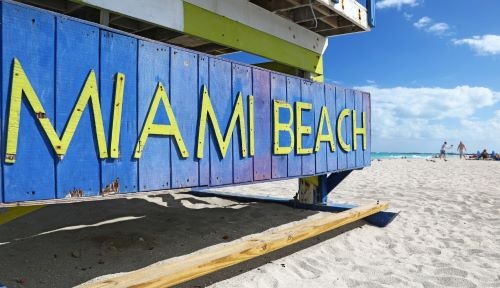 a blue and yellow sign that says miami beach