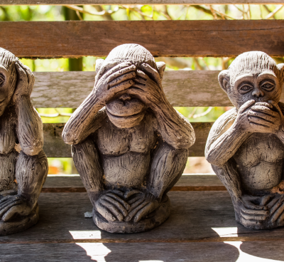three wise monkeys sitting on a bench with their hands on their chins