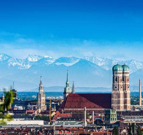 a city skyline with mountains in the background