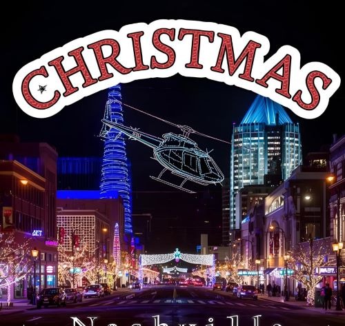 Festive Christmas lights and holiday decorations line Broadway in downtown Nashville at night.