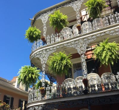 new orleans - a building with a balcony and a balcony with plants
