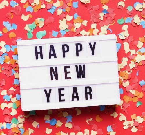 A white lightbox with Happy New Year text on a red background with colorful confetti.