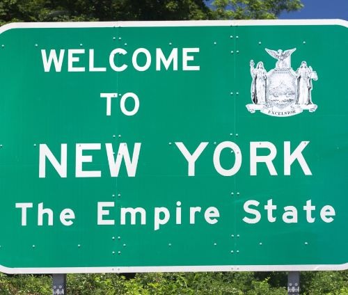 a green sign that says welcome to new york