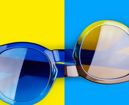 a pair of sunglasses with a pair of sunglasses on a yellow and blue background