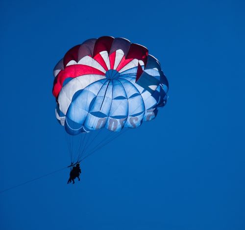 a person parasailing a parachute in the sky