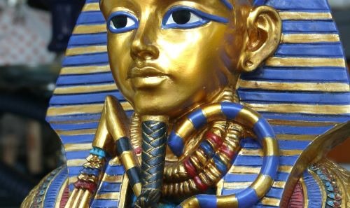 a golden statue of a pharaoh in a golden mask