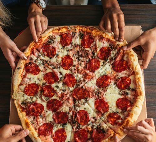 a pizza with pepperonini pizza on a table
