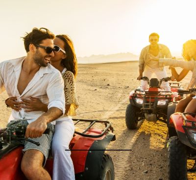Quad Bike - a man and woman riding on four wheelers