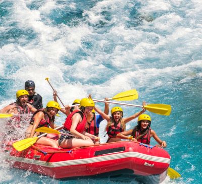 a group of people rafting down a river