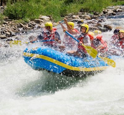 a group of people rafting down a river