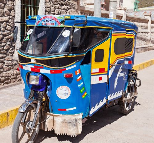 a blue and yellow rickshaw