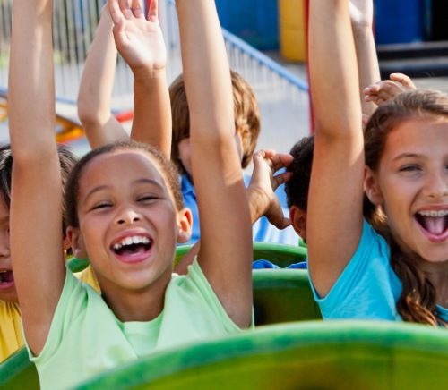 a group of children's playing on a roller coaster