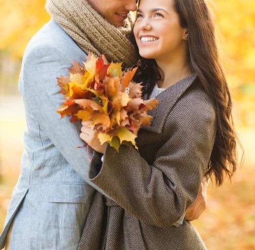 a man and woman embracing in autumn