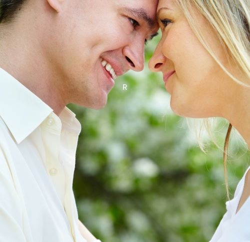 a man and woman smiling at each other