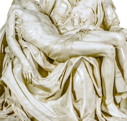A close-up view of Michelangelo's Pieta marble sculpture showing the detailed body of Jesus in Mary's lap.