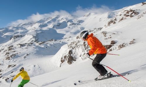 two people skiing down a mountain slope