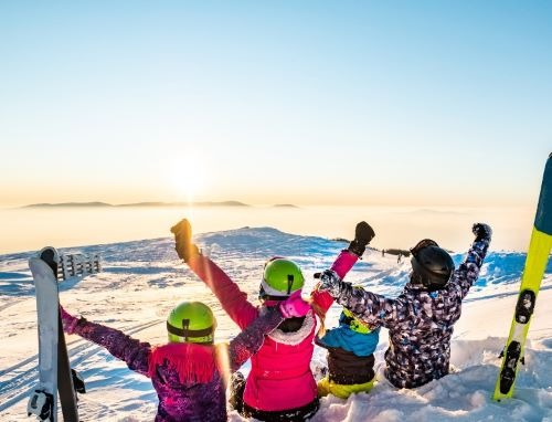 a group of people standing on top of a snow covered ground
