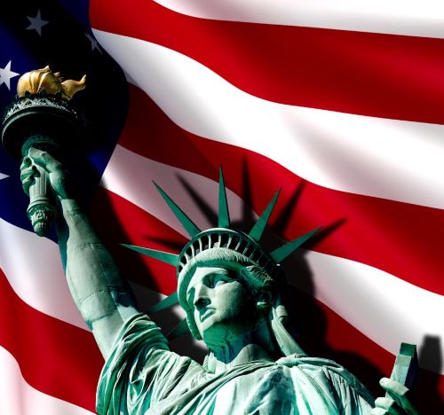 a statue of liberty in front of a flag