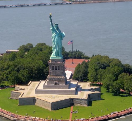 a statue of liberty in front of a body of water