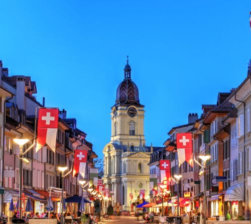 a street scene with a church steeple and a clock tower