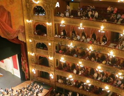 a large auditorium with a large audience watching a performance