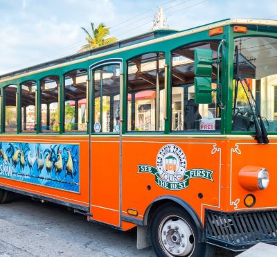 a trolley bus with a colorful bus on the side
