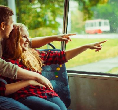 trolley bus - a man and woman sitting on a bus