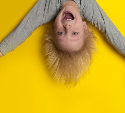 a young boy upside down