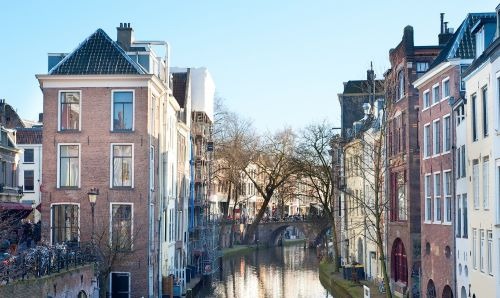 a canal with a boat  in a canal in utrecht