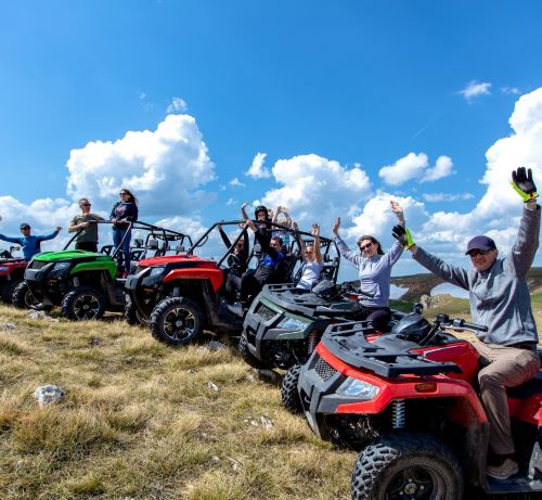 a group of people riding on four wheelers