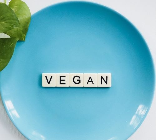 plates with sign “vegan” on it