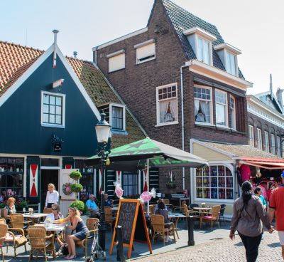 a group of people walking down a brick street