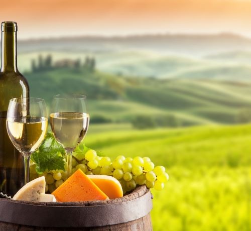 a wine barrel with wine glasses and a bottle of wine