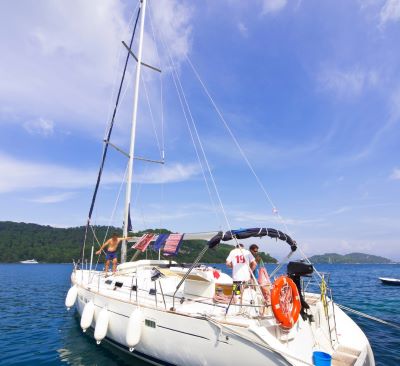 a sailboat in the water with a life preserver