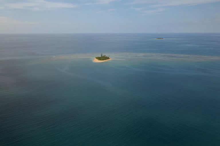 a small island with a small island in the middle of the ocean