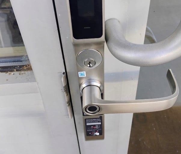 Biometric keypad smart lock on commercial building entrance