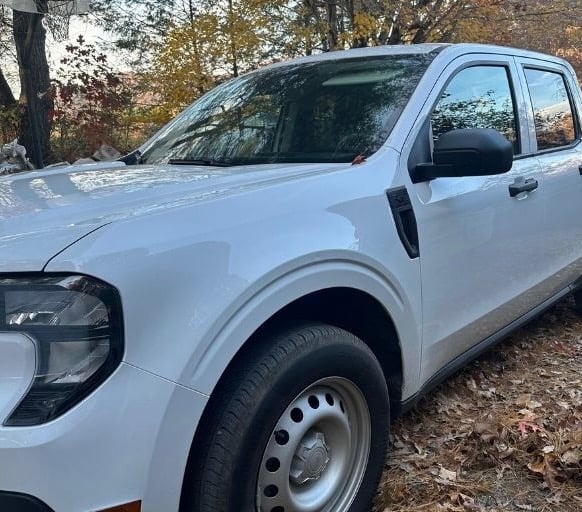 White pickup parked in a wooded residential driveway in Fairview, North Carolina