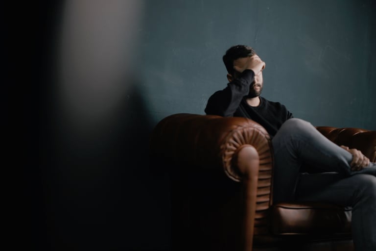 Frustrated guy sitting on chair