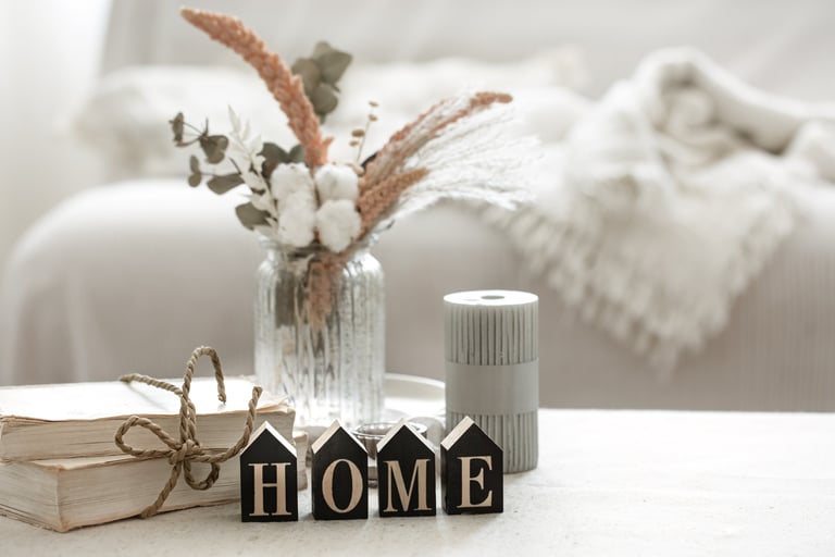 Cozy home vignette with flowers and HOME letters on a table, representing KLEAN WELL’s friendly serv