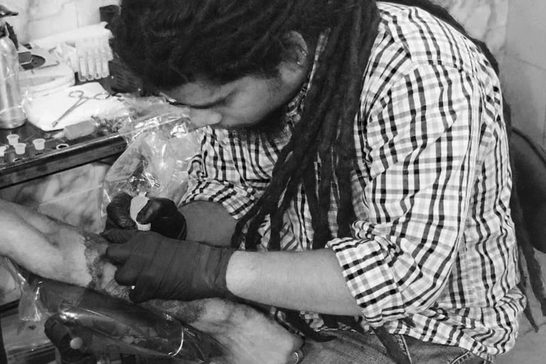 About us page showing tattoo artist tattooing ink on a client, against the mission section