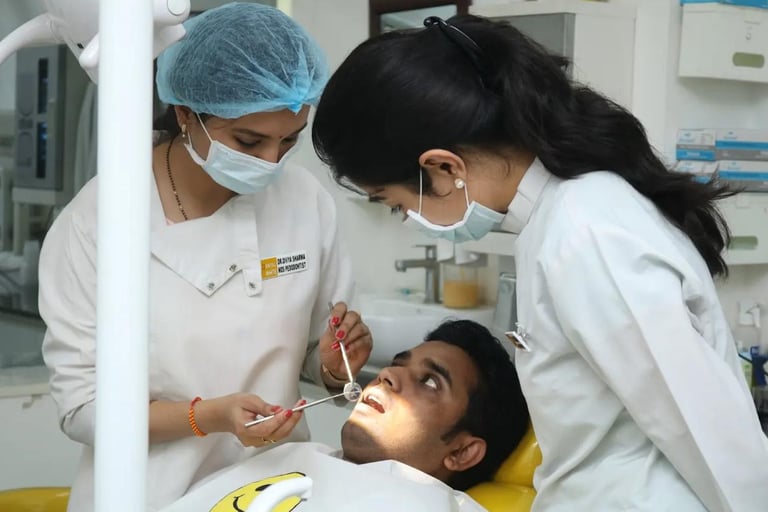 a dentist's assistant is showing a patient a dental mirror