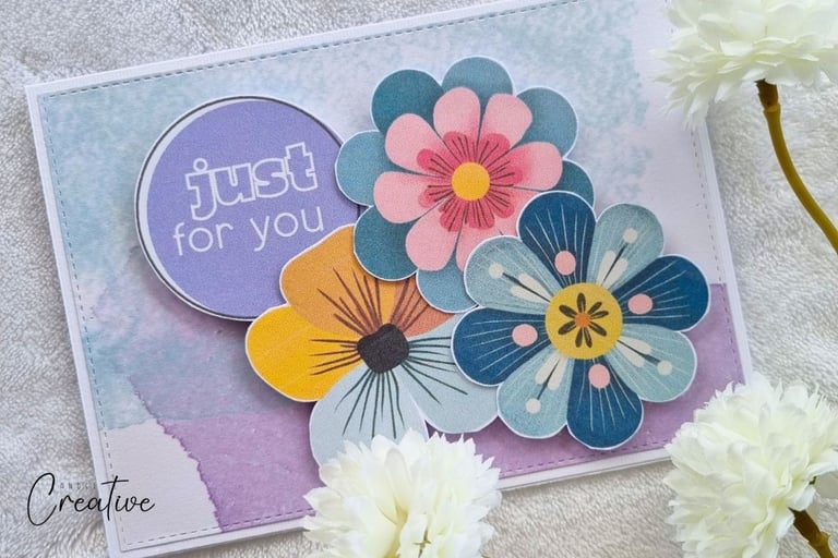 Handmade card with watercolor background, clustered colorful flowers and "Just for you" sentiment.